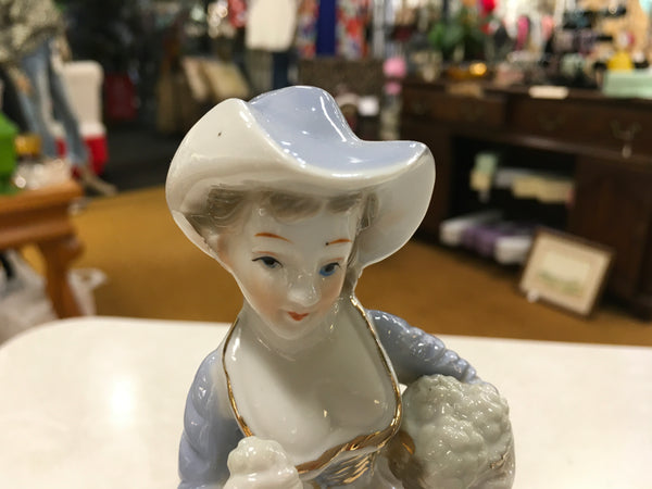 Porcelain girl with grapes figurine