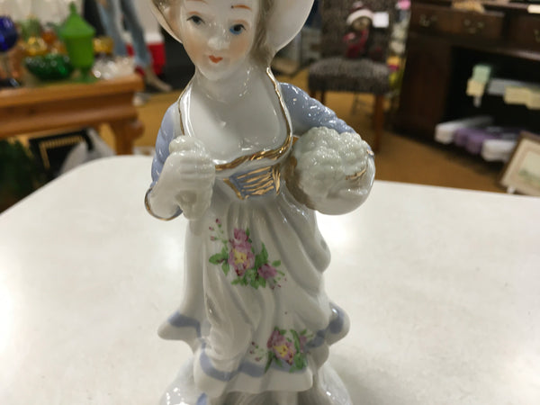 Porcelain girl with grapes figurine