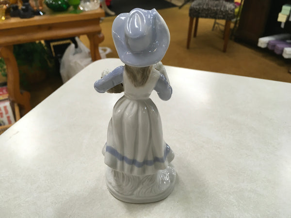 Porcelain girl with grapes figurine