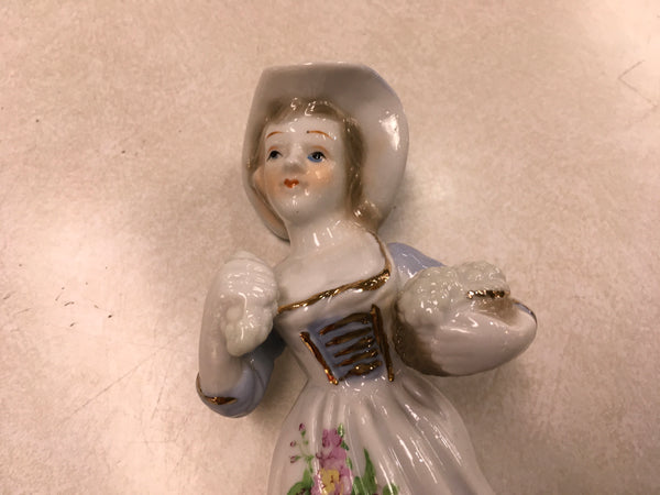 Porcelain girl with grapes figurine